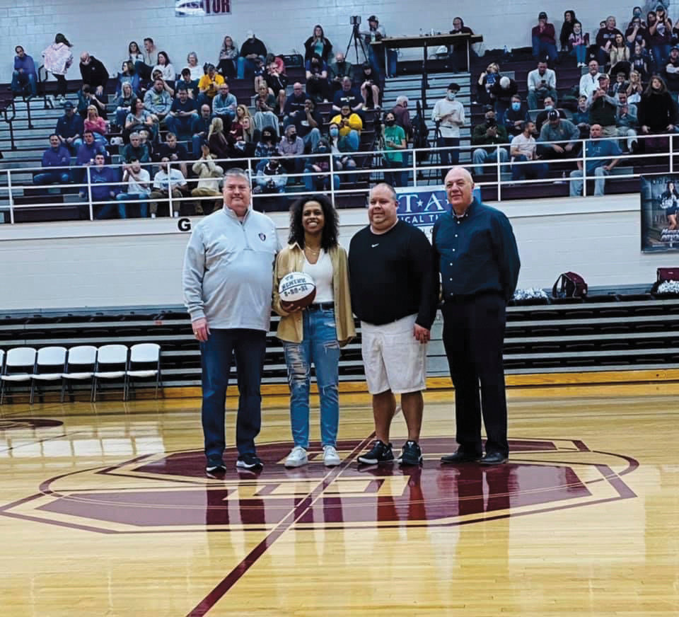 Friday night during the McMinn County game, Warriorette Mia Murray made her 1,000th point. L-R: Greg Wilson, White County High School principal; Mia Murray; Coach Mike Dodgen; and Terry Crain, White County schools athletic director.